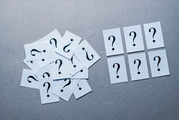Still life of printed question mark on white paper
