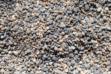 Sea pebble texture. Small rocks. Small multicolored pebble-stones. Beach stones surface.