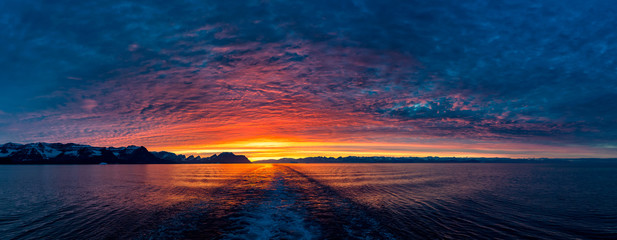 Bright sunset in Greenland at the sea with clouds