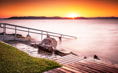 Pier with sunset at lake Balaton
