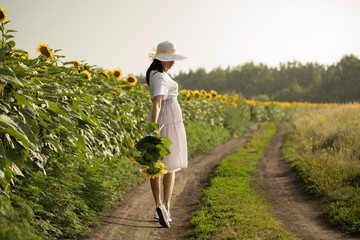 Girl with flowers. girl with flowers walking in the field in the rain.