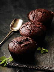 Muffins on dark background. Closeup selective focus.