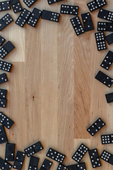 Domino's tiles create a border on a wood background