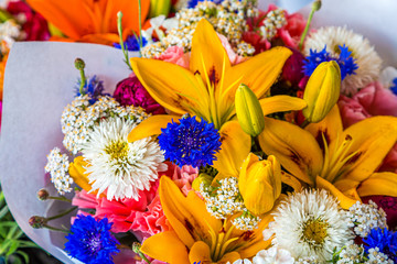 A Colorful Bouquet of Lilies and Mums in a Flower Market