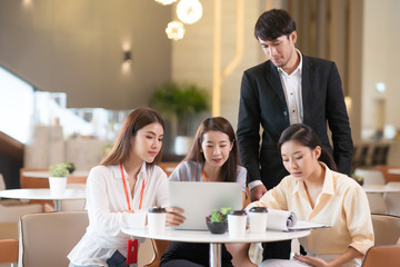 Young Asian woman and business people are meeting in office discussion with colleagues . Group of Business team working and share ideas about project to partners