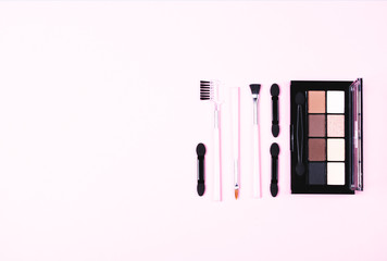Make-up woman essentials on pink.