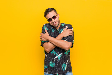 Fototapeta premium Young filipino man wearing summer clothes hugs, smiling carefree and happy.