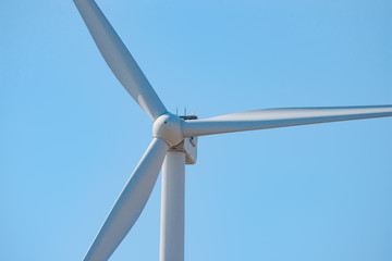 Wind Generator Turbine on the Blue Sky Bacground. Green Renewable Energy Concept.