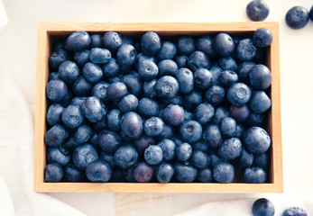 Box with fresh blueberry on table, top view