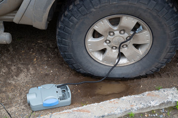 Pumping a car tyre compressor. Autonomous car electric pump.