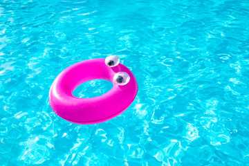 Inflatable ring floating in swimming pool on beautiful sunny day