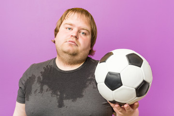 Caucasian crazy blond fat man playing football