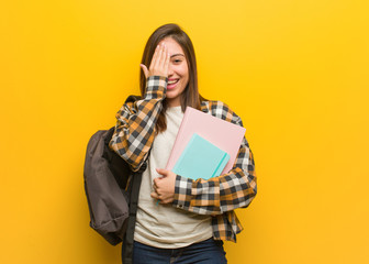 Young student woman shouting happy and covering face with hand