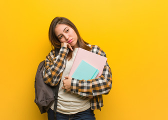 Young student woman thinking of something, looking to the side