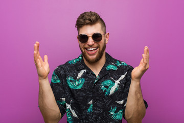 Young man wearing a vacation look joyful laughing a lot. Happiness concept.