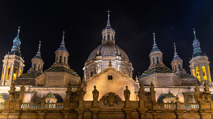Scenic night view with illuminated cupolas and towers of the Cathedral of Our Lady of the Pillar in Zaragoza, Aragon, Spain
