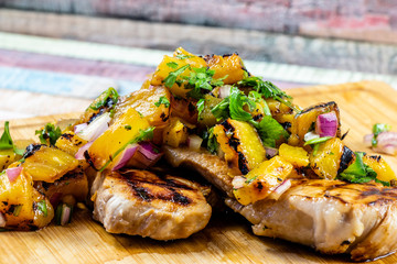 Marinated pork chops with grilled pineapple salsa. Calgary, Alberta, Canada