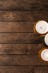 Beer glasses on wooden table with copyspace.