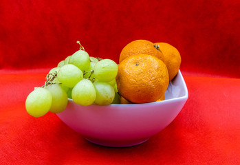 Colourful fruit in a white bowl against a colouful back drop. Calgary, Alberta, Canada