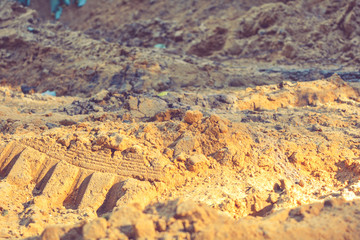 Dirt and sand in random with small stones. Close-up of sand soil background