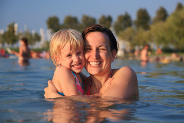 Fototapeta premium Mother with her cute child in water