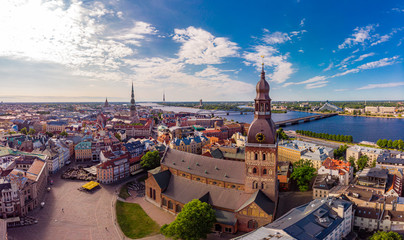 Beautifull aerial panoramic view from drone In sunny summer Day to histirical center Riga and quay of river Daugava. Famous Landmark - City Dome Cathedral church and Old Town Monument. Latvia, Europe.