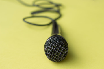 microphone for blogger, journalist or musician work on yellow background. karaoke microphone. top...