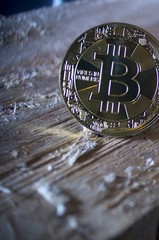 Gold bitcoin on wood surface