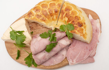 soft cheese, slices of meat and flatbread