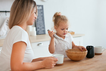 Mother and daughter Cooking in kitchen. Happiness Cooking Activity Concept