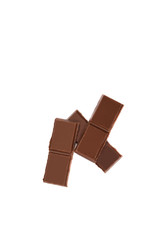 Milk organic chocolate pieces isolated over white background.