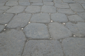 White reflective stones can be seen in a patterned roman road used to light the route at night...