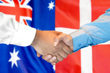 Business handshake on the background of two flags. Men handshake on the background of the Denmark and Australian flag. Support concept