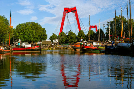 A view of the  Willemsbrug    Bridge  in  Rotterdam. Rotterdam city cityscape skyline. Bright red bridge with a total length of about 318 meters. Netherlands.  Was built in 1878.
