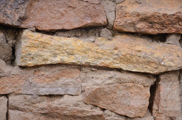  The background consists of a masonry wall with a large die.