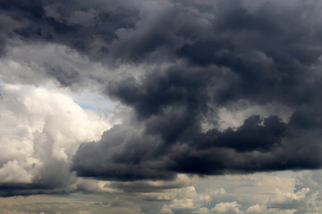 Storm sky covered with dark cumulus clouds before the rain. Dark cloudy sky, overcast day, beautiful dramatic background for rainy weather