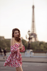 Beautiful girl is walking in Paris with Eiffel tower view , France, summer time