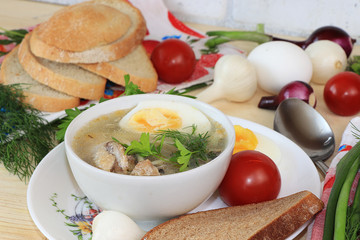 Traditional Russian soup with egg and bread on a wooden table. Delicious traditional natural food and cooking ingredients, healthy eating concept,