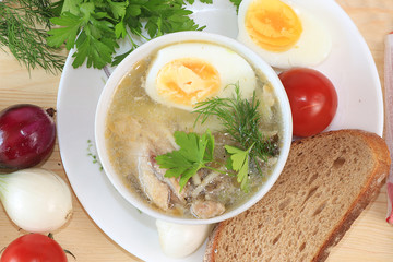 Traditional Russian soup with egg and bread on a wooden table. Delicious traditional natural food and cooking ingredients, healthy diet concept,