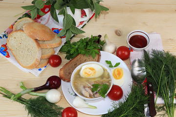 Traditional Russian soup with egg and bread on a wooden table. Delicious traditional natural food and cooking ingredients, healthy diet concept,