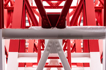 Pylon, red and white painted steel tower. The fragments showing the details of construction, joins, rivets.