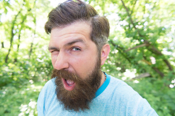 The mustache made me do it. Bearded man winking with stylish mustache shape. Brutal hipster with...