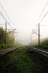 railway tracks going into the fog