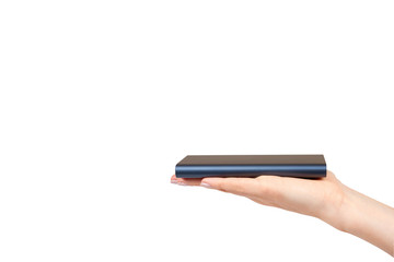 Hand with dark blue power bank for charging mobile devices, external battery.