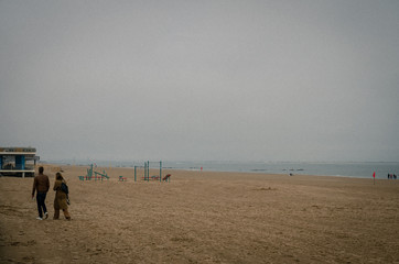 couple walking on the beach at sunset