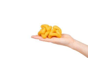 Hand with cheese puff sticks, crunchy corn snack, unhealthy food.