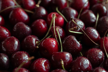 Red ripe fresh cherries in drops of water close-up. Cherry background. Berry pattern and texture. Food background.