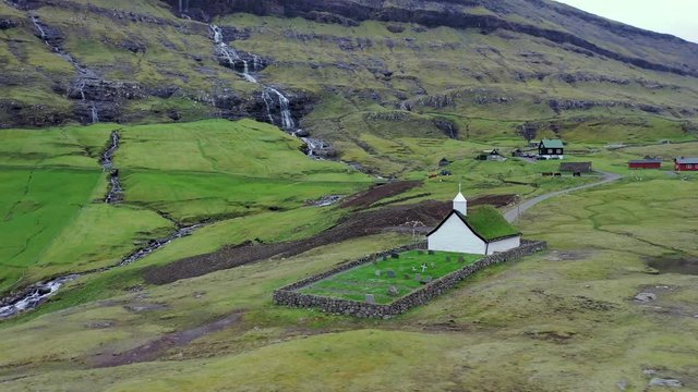 Flying around a small village church in Saksun, Faroe Islands, Denmark