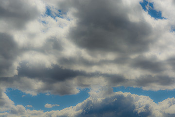 several cumulus clouds over blue sky
