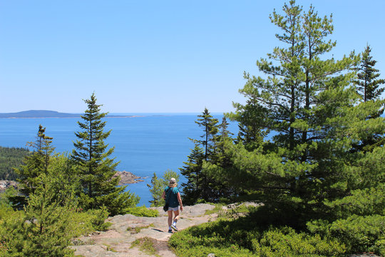 Woman walking on the Gorham Mountain Trail at Acadia Naitonal Park in summer